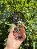 Spells and potions acrylic bookmark with black ribbon held outdoors